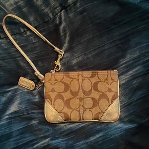 Coach wristlet with gold trim